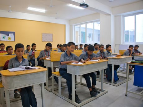 Pupils working at desks in a school classroom